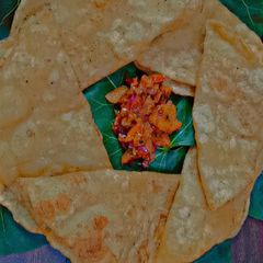 A picture of Aloo poori with tomato chutney.