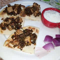 A picture of Chicken with pita bread.