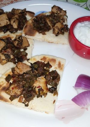 A picture of Chicken with pita bread.