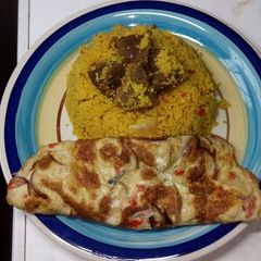 A picture of Couscous jollof/fried egg.