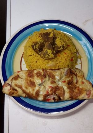 A picture of Couscous jollof/fried egg.