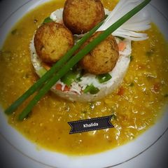 A picture of Daal Masoor with egg fried rice and potato,rice balls.