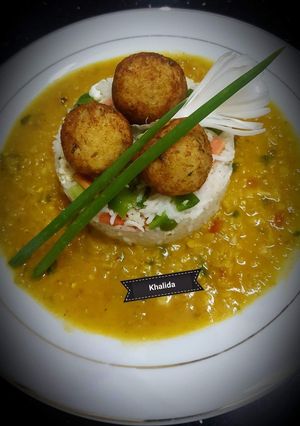 A picture of Daal Masoor with egg fried rice and potato,rice balls.