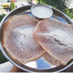 A picture of Appam with coconut milk.