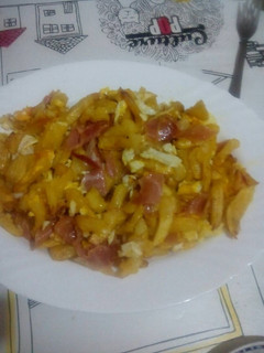 Una foto de Patatas con jamón y huevos rotos