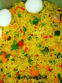 A picture of My stir fry noodles with boiled eggs and veggies.