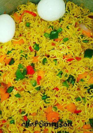 A picture of My stir fry noodles with boiled eggs and veggies.