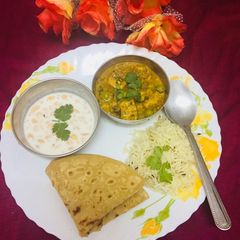 A picture of Mater paneer bundi raita jeera rice paratha(In proper lunch thali).