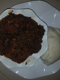 A picture of Bitter Leaf Soup With Fried Fish.