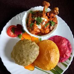 Dry red chilli tomato chicken curry with spinach, beetroot and mango poori A picture of Dry red chilli tomato chicken curry with spinach, beetroot and mango poori.