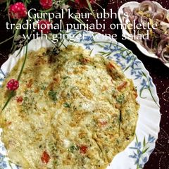 A picture of Traditional Punjabi omelette with ginger wine salad 🥚🫚🍷🥗.