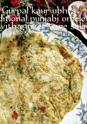 A picture of Traditional Punjabi omelette with ginger wine salad 🥚🫚🍷🥗.