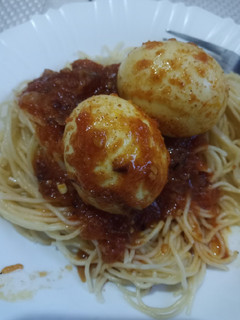 A picture of Egg curry with spaghetti.