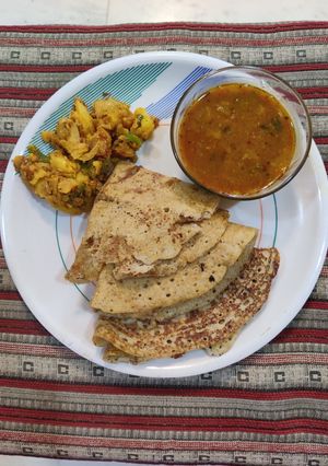 A picture of Bajra moong urad dal masala dosa and sambhar.