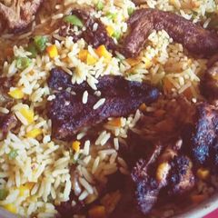A picture of Fried rice with grilled chicken.