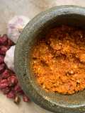 Red Coconut chilli chutney in pestle and mortar