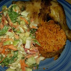 A picture of Jollof Rice, Veg Salad and Chicken.