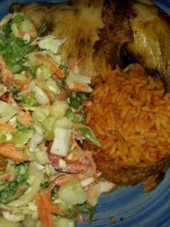 A picture of Jollof Rice, Veg Salad and Chicken.
