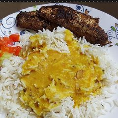 A picture of Butter rice khatti daal with fried fish.