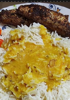 A picture of Butter rice khatti daal with fried fish.