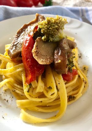 A picture of Fettuccine with Piccadilly Tomatoes, Porcini Mushrooms, and Sicilian Broccoli.