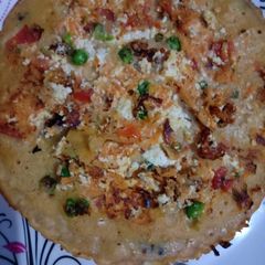 A picture of Besan chila filled with paneer and veggies.