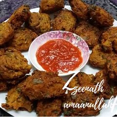 A picture of Moong Daal Fritters with Purslane Leaves.