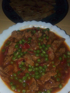 A picture of Stewed meat and peas.