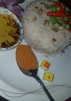 A picture of Rice and beans with oil and pepper.