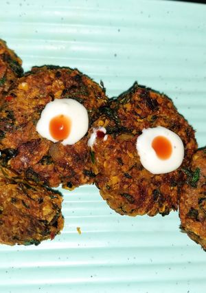 A picture of Oats tikki with leafy vegetables.