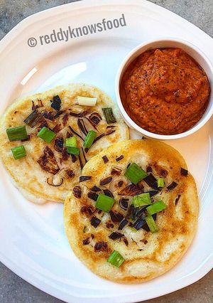 A picture of Crispy shallots Uthappam with spicy tomato garlic chutney.