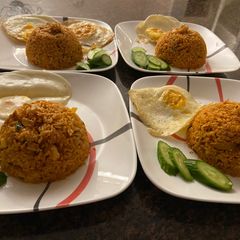 A picture of Indonesian style red fried rice (hot).