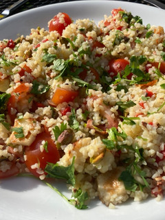 A picture of Bulgur salad with halloumi, pistachios and cilantro.