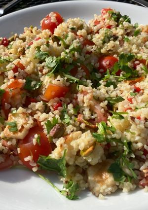 A picture of Bulgur salad with halloumi, pistachios and cilantro.