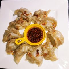 A picture of Dumplings or Momos Served With Chilli Oil.