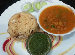 A picture of Black Chana Curry with fried rice.