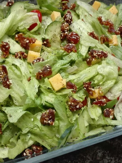 A picture of Simple salad topped with sesame Dates.