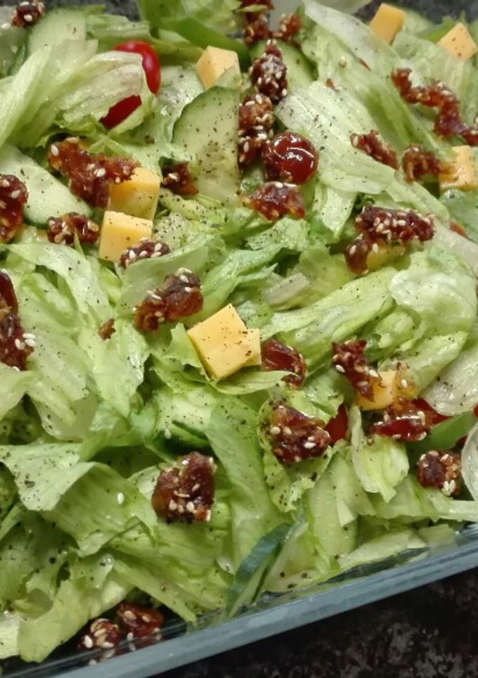 A picture of Simple salad topped with sesame Dates.
