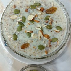 A picture of Broken Wheat Kheer with pumpkin seeds.