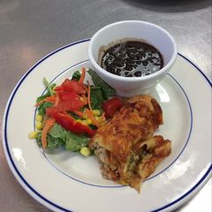 A picture of Chicken Enchiladas w/ Black Beans and Mexican Chopped Salad.