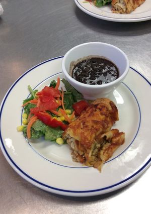 A picture of Chicken Enchiladas w/ Black Beans and Mexican Chopped Salad.