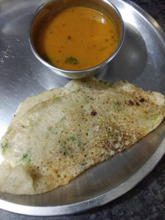 A picture of Semolina dosa with Sambhar.