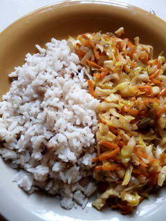 A picture of Rice and beans with cabbage and carrots sauce.