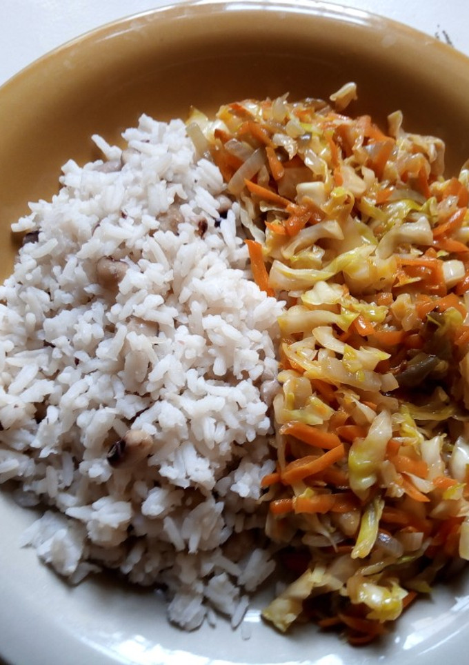 A picture of Rice and beans with cabbage and carrots sauce.