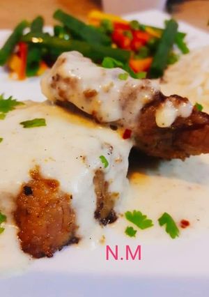 A picture of #Beef_Steak_with #White_Sauce and #Sauté_Vegetables.