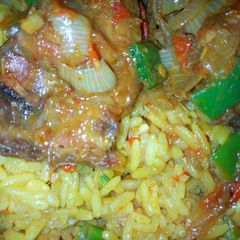 A picture of Fried rice with peppered chicken.
