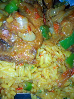 A picture of Fried rice with peppered chicken.