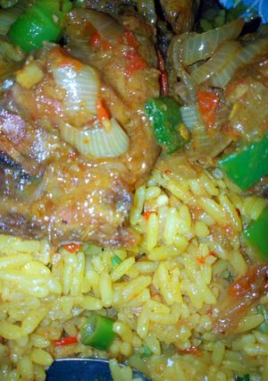 A picture of Fried rice with peppered chicken.