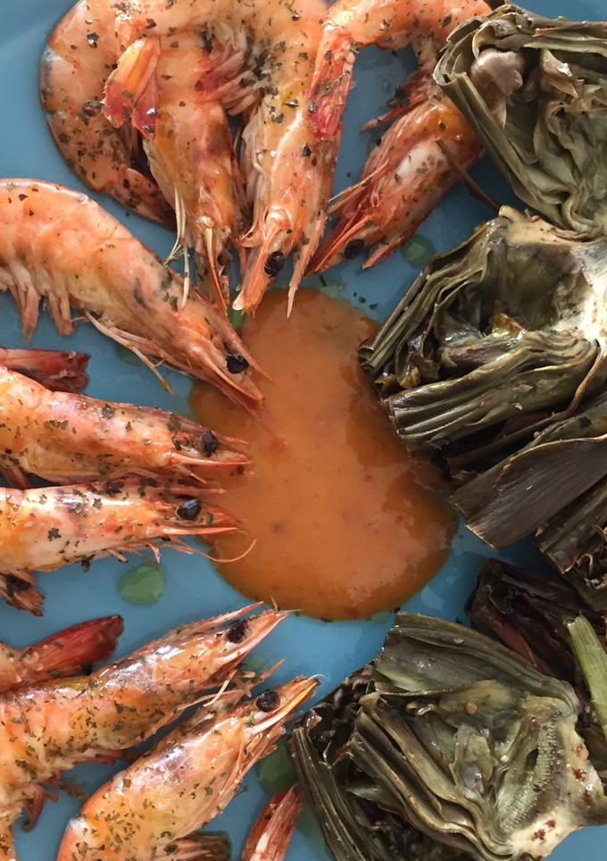 Una foto de Langostinos con alcachofas al horno