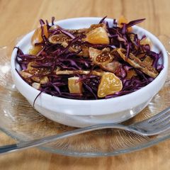 A picture of Red cabbage salad with clementines and dried figs.